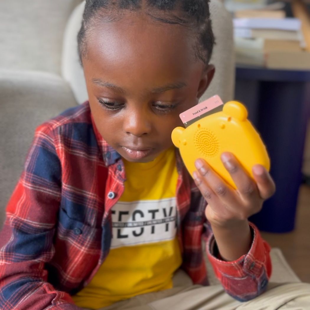 Young boy playing with Twi Talking Flashcards device.