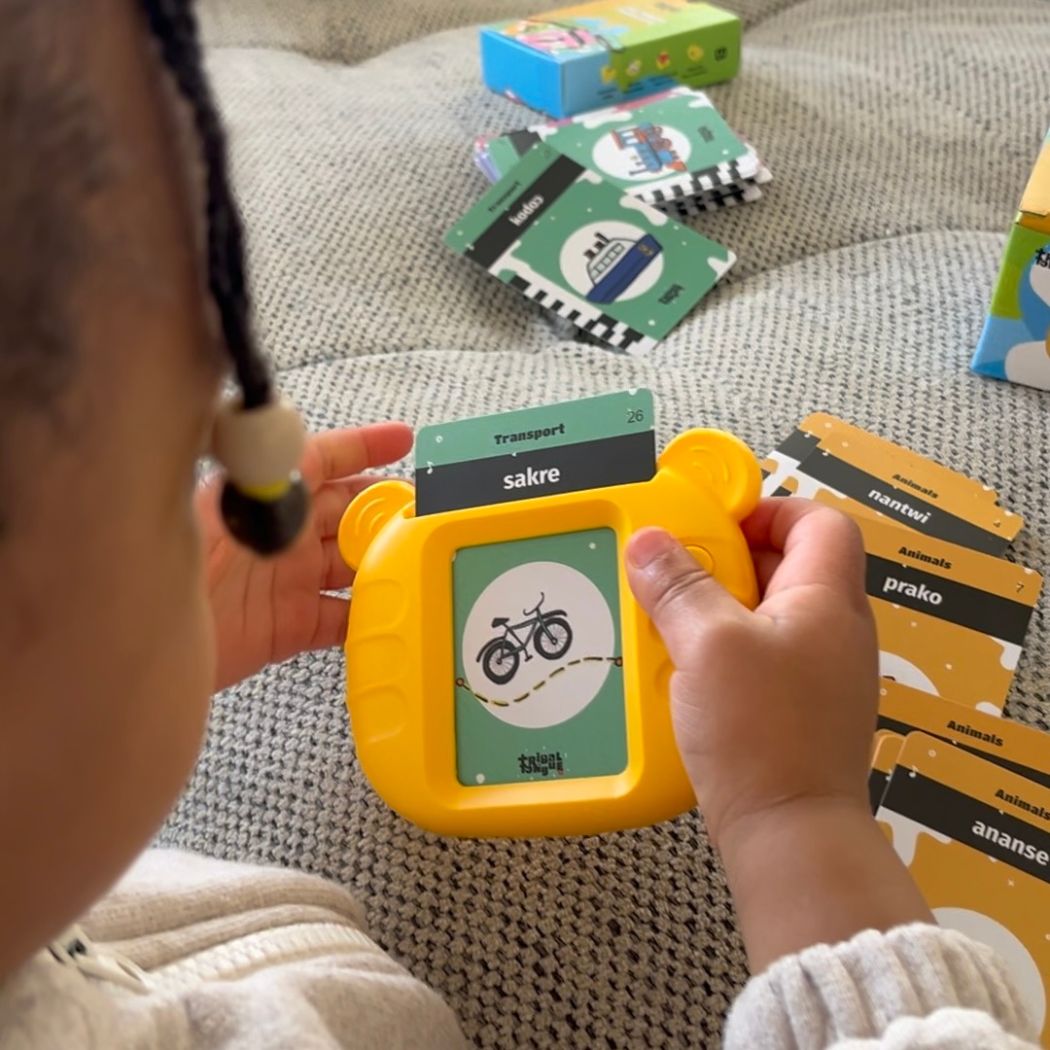 Young kid holding Twi Talking Flashcard device with bike card sakre