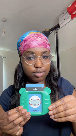 Young lady demonstrating the Igbo Talking Flashcards, inserting cards and repeating the words.